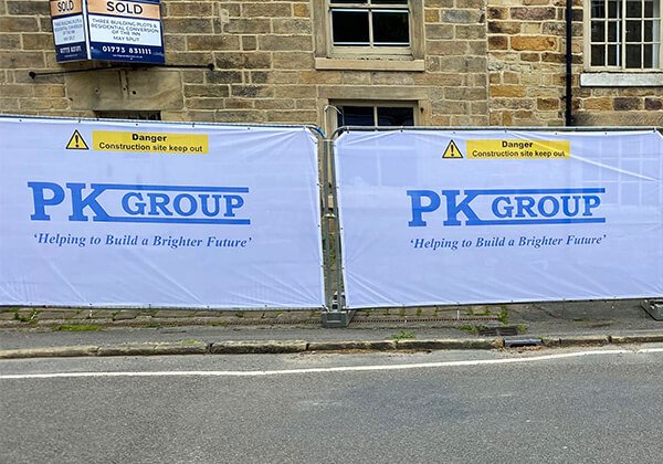 White Airmesh Heras Fence Covers printed with PK Group branding