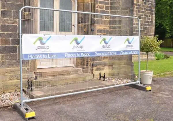 Heras Fence Banner attached to a Heras Fence for Jessup Homes