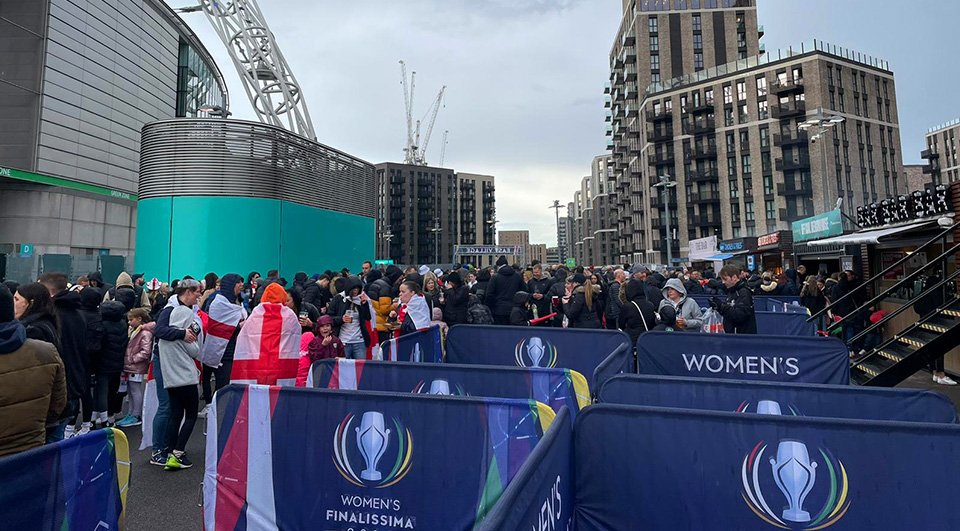 Branded barriers in use to manage crowd control at the Women's Finalissima at Wembley