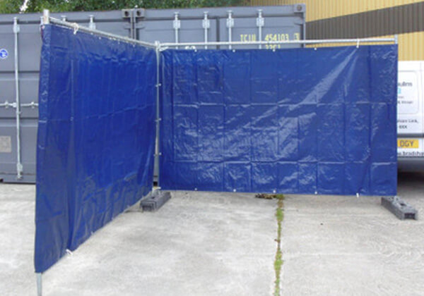 Image of blue fence tarpaulin attached to Heras fencing