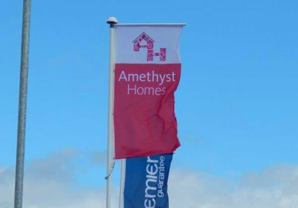 Closeup of showhome flagpoles for Amethyst Homes