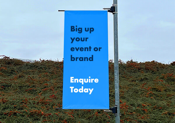 Image of lamp post banner stating "Big up your vent or brand - Enquire today"