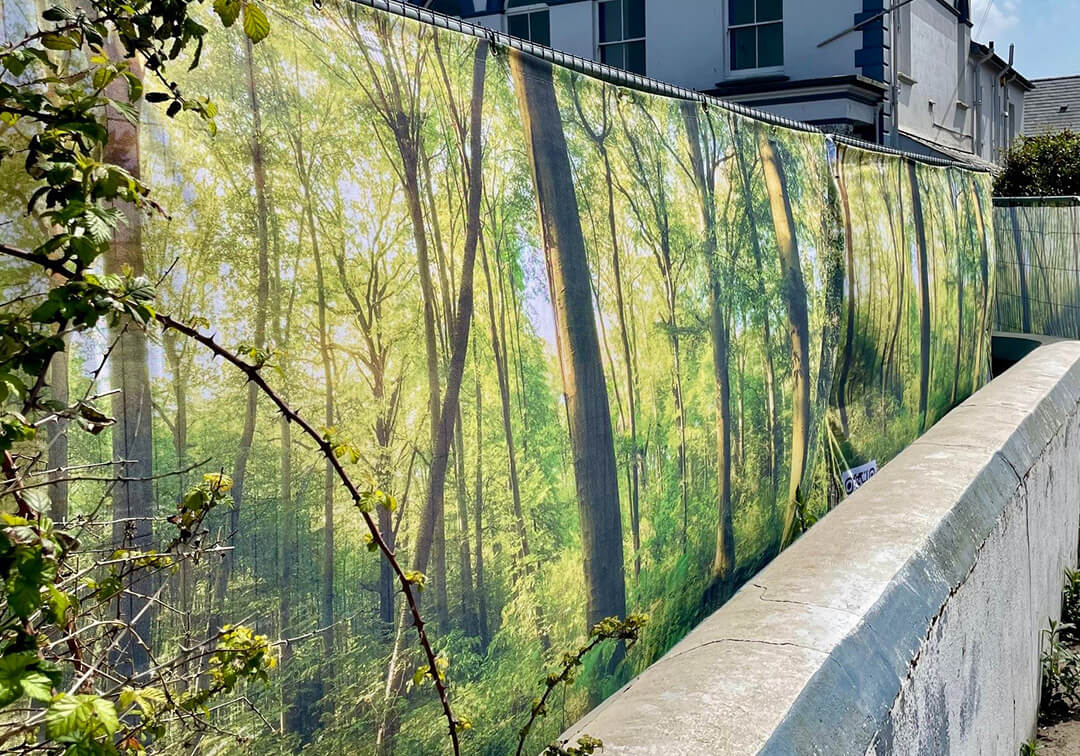 Pre-designed Heras fence covers with a forest design