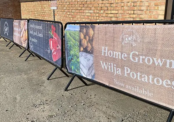 Crowd Barrier Covers advertising home grown potatoes