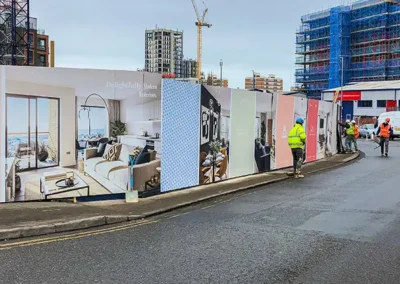 Hoarding signage being installed