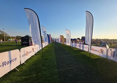 Custom feather flags and barrier covers with Keswick Walk branding