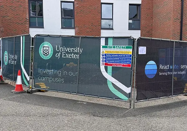 Heras fence cover with University of Exeter branding
