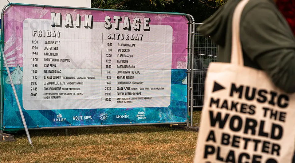 PVC mesh Heras fence covers used to give stage time information at a festival