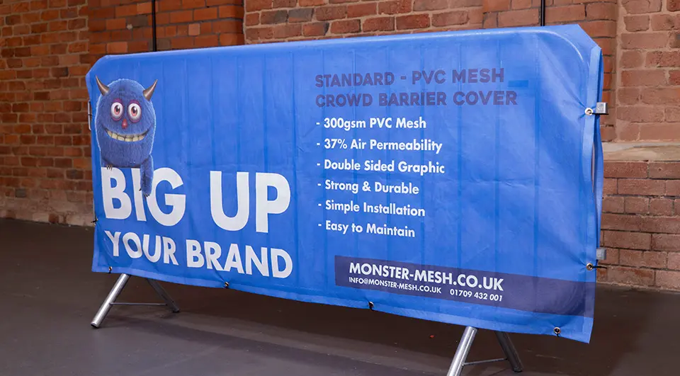 Best Crowd Barrier Covers for Your Budget 3 A Standard PVC mesh crowd barrier cover with stitched angled corners, showing a tidy double-sided fit over a metal crowd control barrier.