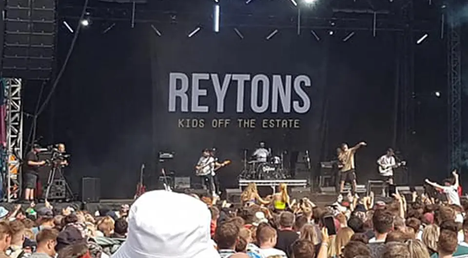 The Reytons band backdrop on the Tramlines Festival main stage, white text on black