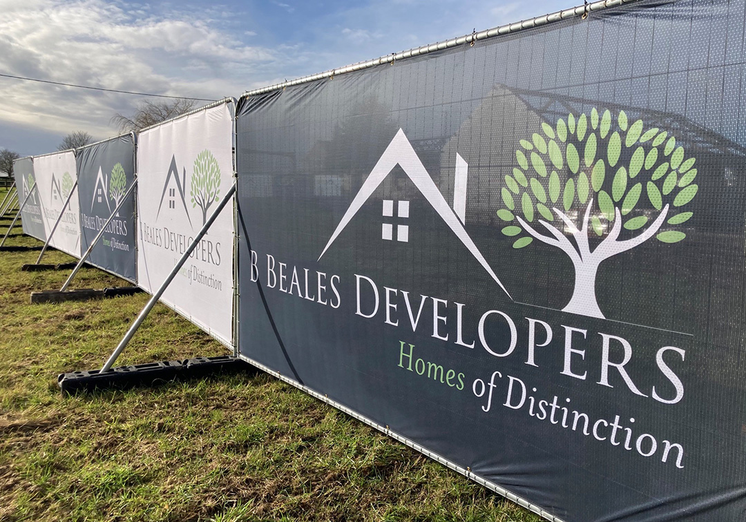 best-heras-fence-covers-windy-sites-category-tile Printed Heras fence covers on an outdoor site, showing B Beales Developers branding on mesh panels