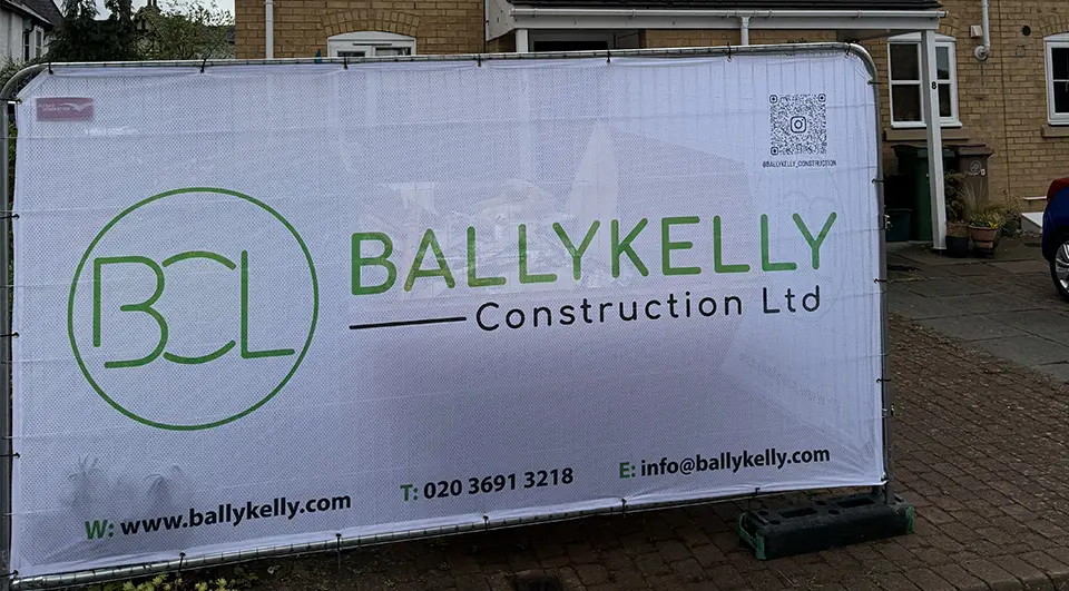 Best Heras Fence Covers for Site Security 5 Airmesh Heras fence cover with Ballykelly Construction branding outside a house.