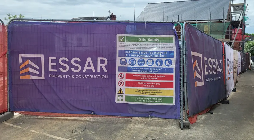 Best Heras Fence Covers for Site Security 3 Elite Heras fence covers with Essar Property & Construction branding and a site safety sign.