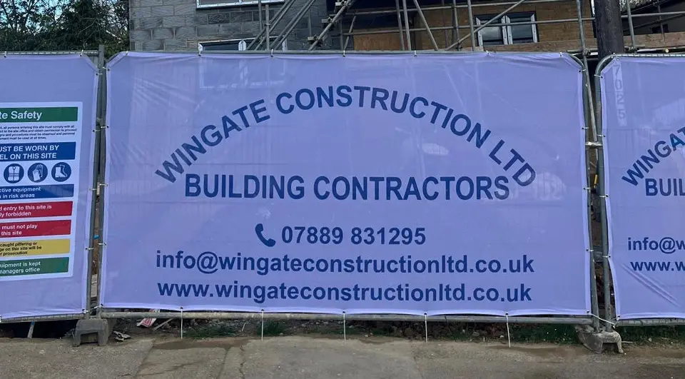 Best Heras Fence Covers for Site Security 2 Branded Heras fence covers with a site safety sign on a residential construction site.